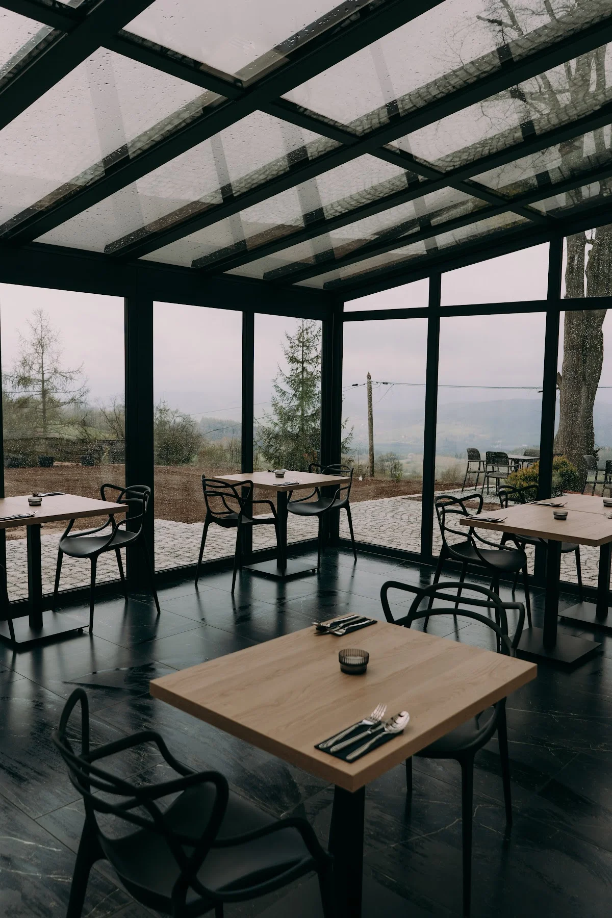 Taras restauracji z eleganckimi meblami pod dachem.