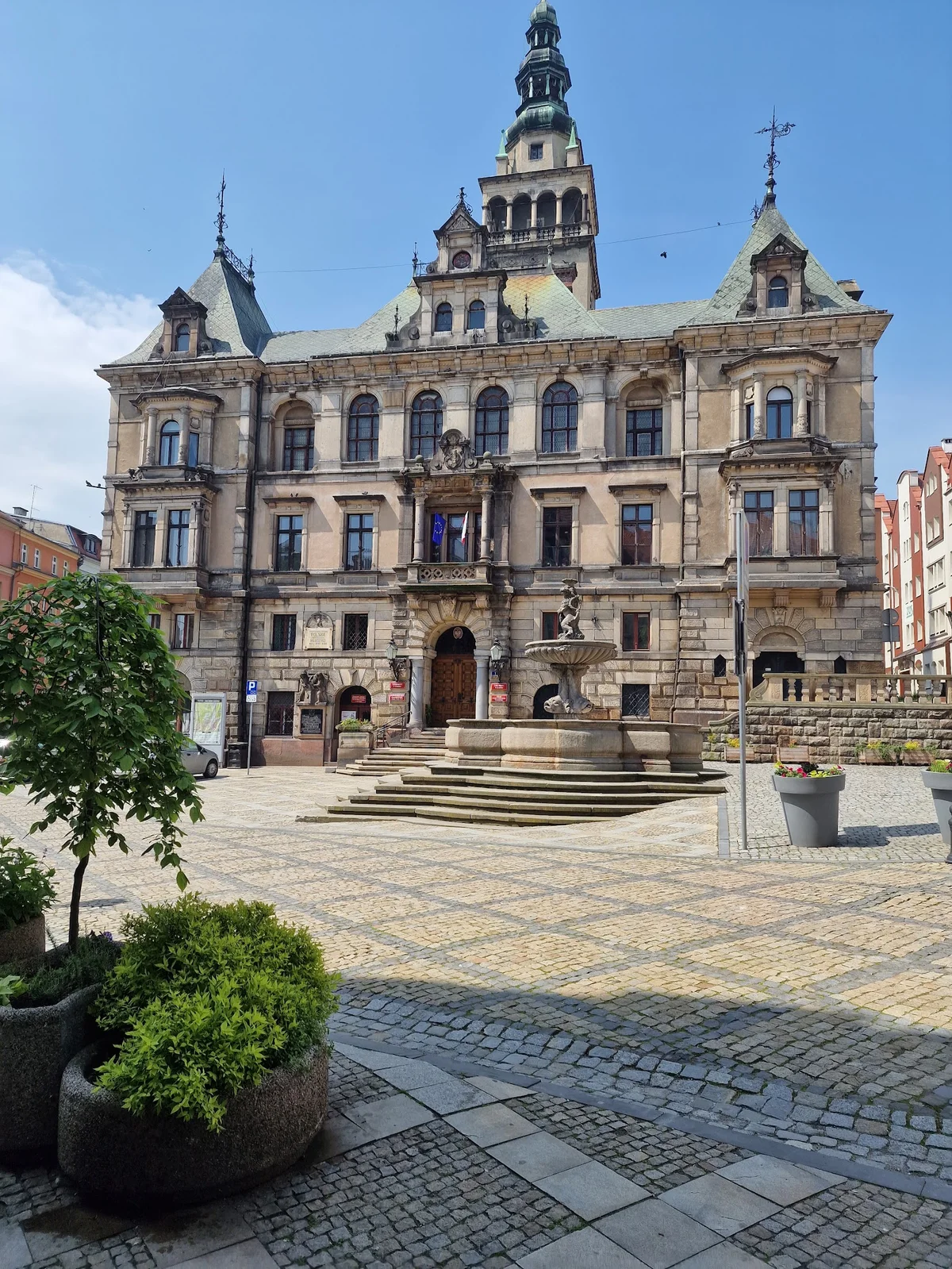 Panorama miasta o zachodzie słońca pod niebem z wieżą pod słońcem pod dębem.